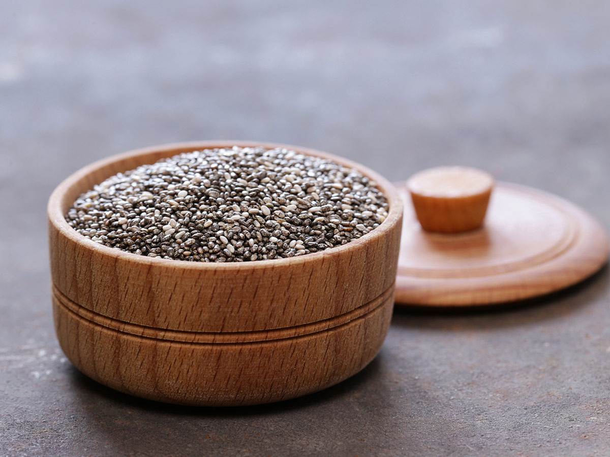 Fresh chia seeds on a wooden bowl