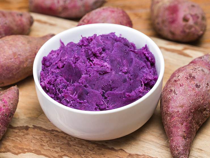 Purple mashed sweet potatoes in a bowl