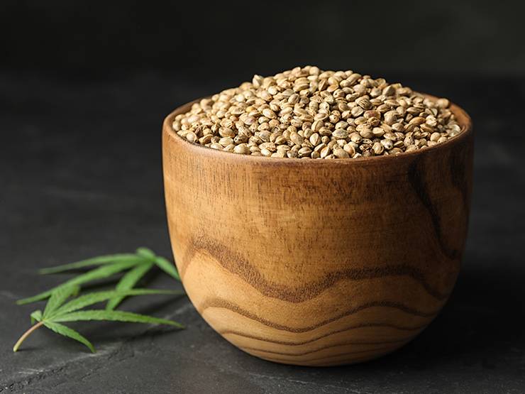 Organic hemp seeds in a wooden bowl