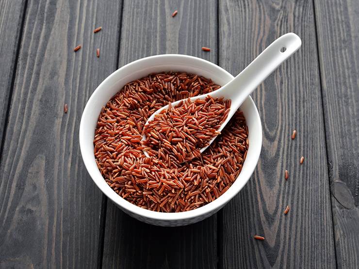 Uncooked red rice on a white bowl