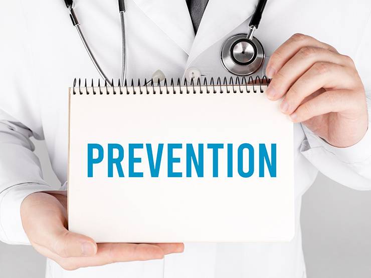 A vet holding a card with the word prevention written on it